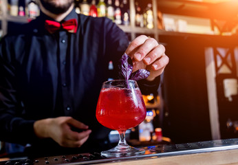 Bartender is making cocktail at bar counter. Fresh cocktails. 