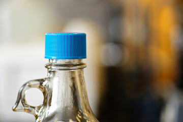 Chemical bottle with a protective blue cap preventing leakage and spillage.