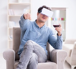 Young man drinking wine at home