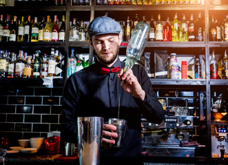 Bartender is making cocktail at bar counter. Fresh cocktails. 