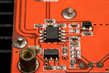 The board is red with microchips on it