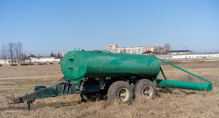 Water trailer stands in the field