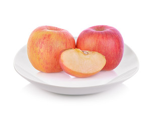Apple on plate isolated on white background.