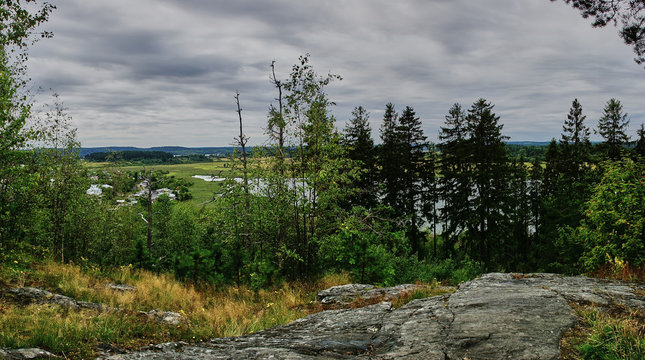 Panorama of Karelian nature from a height.Panoramic view of the surroundings of Sortavala from a hill in a city park: a forest of conifers, traces of volcanic lava, rocks and volcanic rocks. Russia