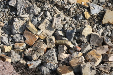 Construction waste with elements of and destroyed old structures at municipal landfill