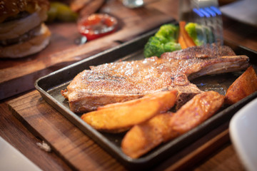 Pork chop or grilled pork served with french fries