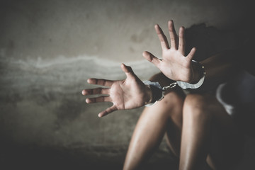 woman hands in handcuffs, human trafficking Concept, stop violence against women and human trafficking,  international women's day.
