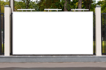 Horizontal billboard on the fence of a city park.