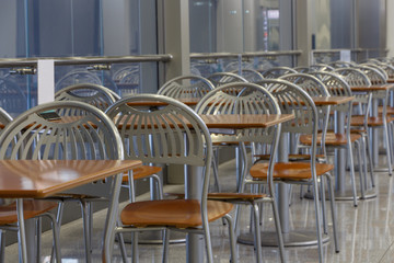 Empty cafe interior, high windows, perspective.