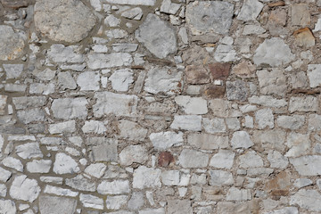 Grey stone wall from an historic castle as texture and background