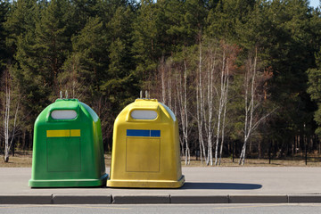 Containers for separate waste collection near the forest. The concept of respect for nature and recycling.