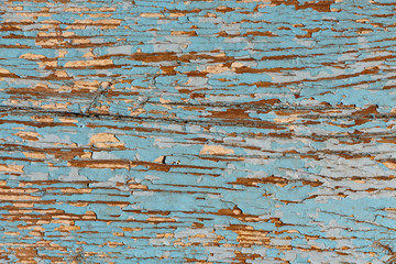 Blue board weathered with cracks, horizontal fibers.