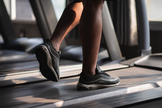 Close Up Of Feet Sport Man Using Treadmill In The Gym