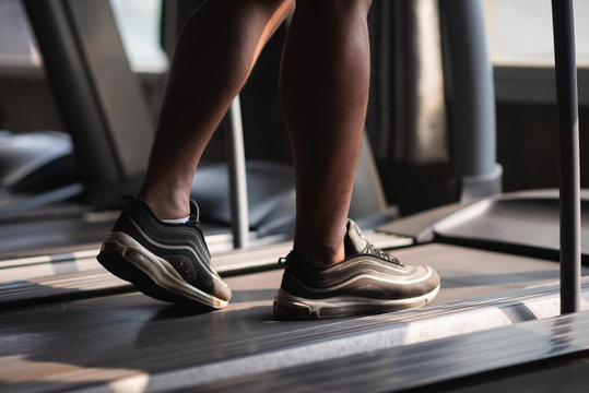 Close Up Of Feet Sport Man Using Treadmill In The Gym