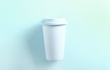 Pastel blue ceramic travel mug on blue background. Top view,flat lay. Tumbler cup on blue background. Zero waste concept.