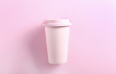 Pastel pink ceramic travel mug on pink background. Top view,flat lay. Tumbler cup on pink background. Zero waste concept.