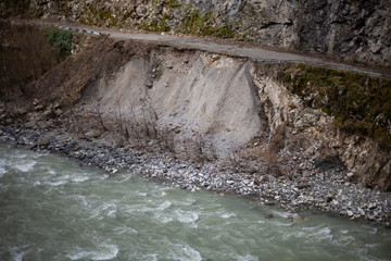 A mountain river flows over stones. The rapid flow of water. Natural background. The speed of...