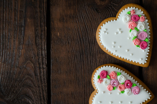 Gingerbread hearts on wooden background with copy space. Top view.