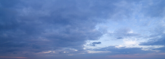 Large panorama of evening sunset sky with beautiful clouds.