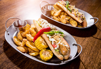 Hotdogs and French fries on a dishes. Fast food meal. Restaurant.