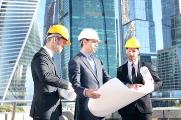 Team of architects comparing project