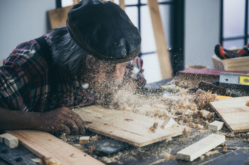 old carpenter man, wooden craftsman working with wood