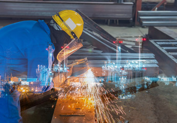 Double exposure of worker cutting carbon steel square tube with Hand Gas Cutting Torches and dressed properly with personal protective equipment(PPE) for safety with power plant background