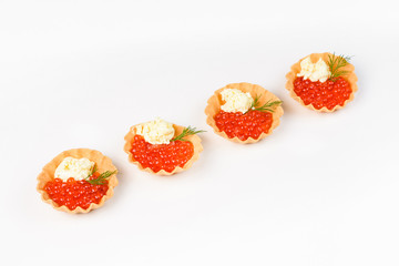 Snack basket with red salmon caviar on a white background