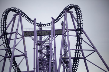 A roller coaster in an amusement park. Relax in fun amusement. Fun for the townspeople. Rail-type metal construction for accelerating the trolley. Fun in the amusement park.