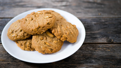 Cashew cookies in a white plate with an old wooden background