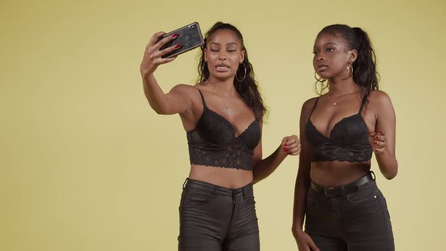 Young Black Girlfriends Posing For Smartphone Selfie