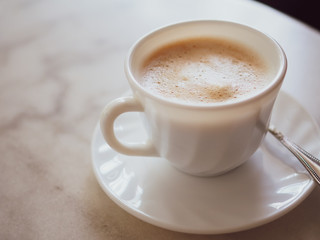 Hot coffee close up on table in cafe