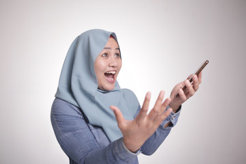 Naklejka premium Muslim Woman Surprised to See Something Above when using Phone