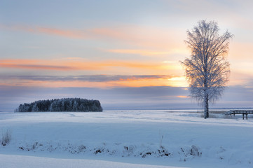 Rosy Sunset in the Lake Pyhaselka, Joensuu, Northern Karelia, Finland in Winter Afternoon of December 2018