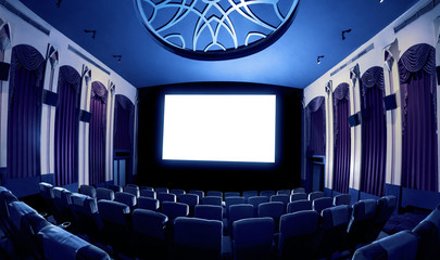 Cinema theater screen in front of seat rows in movie theater showing white screen projected from...