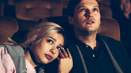 People audience watching movie in the movie theater cinema. Group recreation activity and...