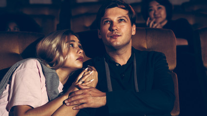 People audience watching movie in the movie theater cinema. Group recreation activity and...