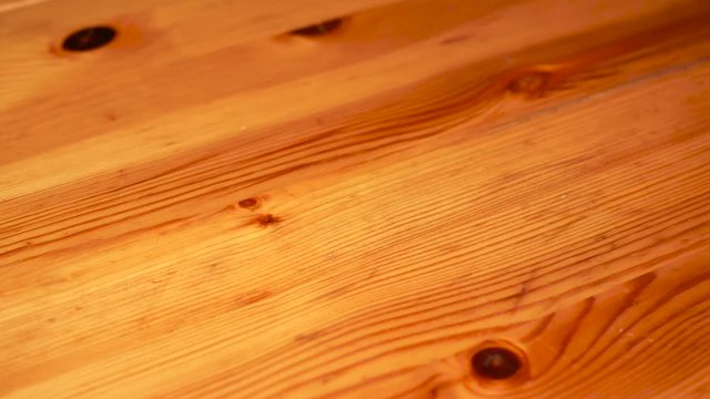 Scratched pine wood board slider shot, camera movement from left to right.