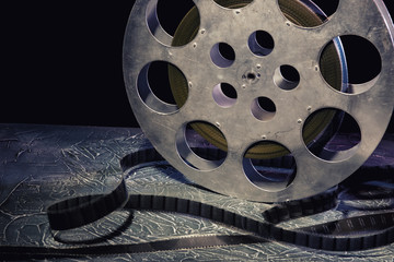 35 mm film reel with dramatic lighting on a dark background