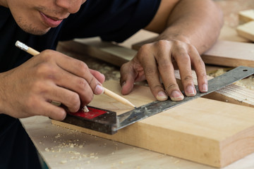 Carpenter working on wood craft at workshop to produce construction material or wooden furniture....