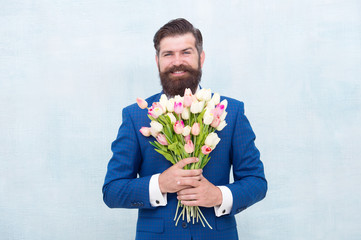 Let me invite you. Bearded man with tulip bouquet. Love date. Womens day. March 8. Spring gift. Bearded man with flowers. Celebrate spring. Gentleman with tulips. Spring is coming. Romantic date