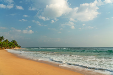 Fototapeta na wymiar Blue ocean waves on sand beach, Sri Lanka