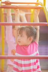 Fototapeta premium School kids play and learn in the playgound. Physical activity like climbing are good for develop movement and muscle in children and improve brain in multifunctions from playing activities.
