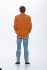 Fototapeta premium rear view. casual young woman looking at white wall