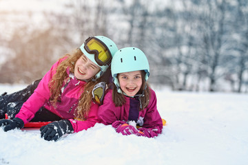 teen friends laugh on a winter day on the ski slope