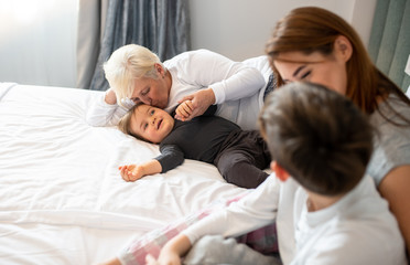 Obraz premium A family having a happy and cheerful time embracing and cuddling.