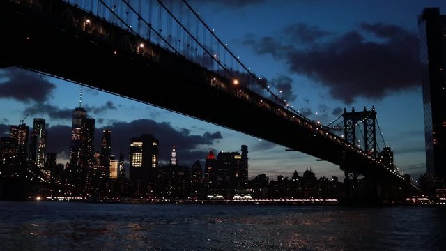 Skyline under Manhattan Bridge at night. NYC