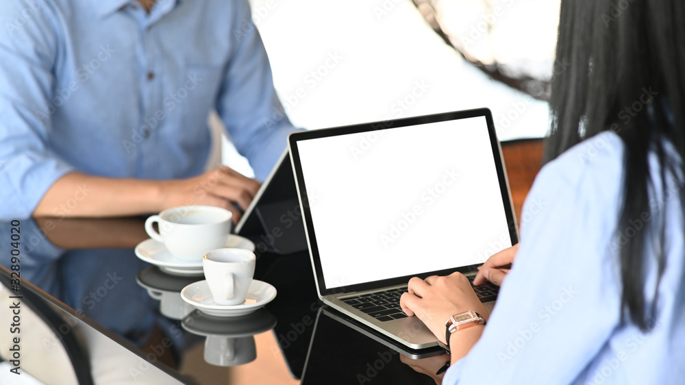 Aufkleber cropped image of business development team working/using a computer tablet and laptop with white bla