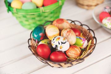 Fototapeta na wymiar Colorful Easter eggs in baskets on table