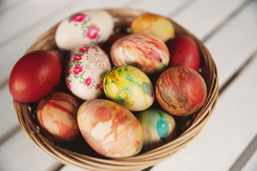 Obraz na płótnie Canvas Colorful Easter eggs in baskets on table